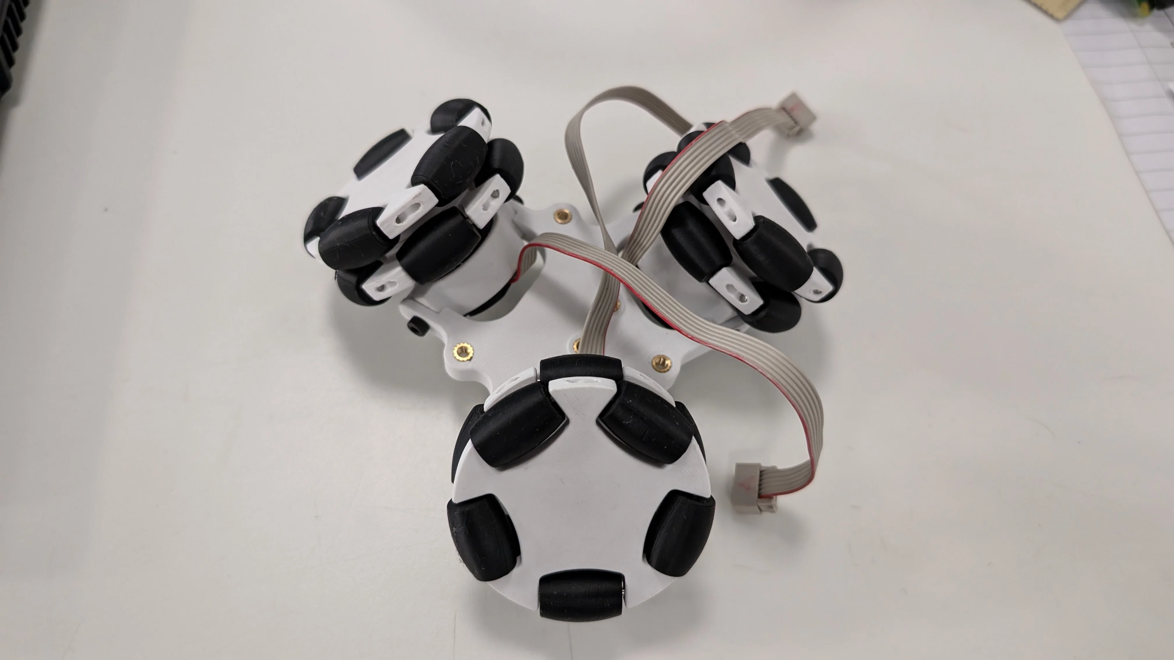 Physical motor mount with omniwheels installed showing final drive assembly on bench